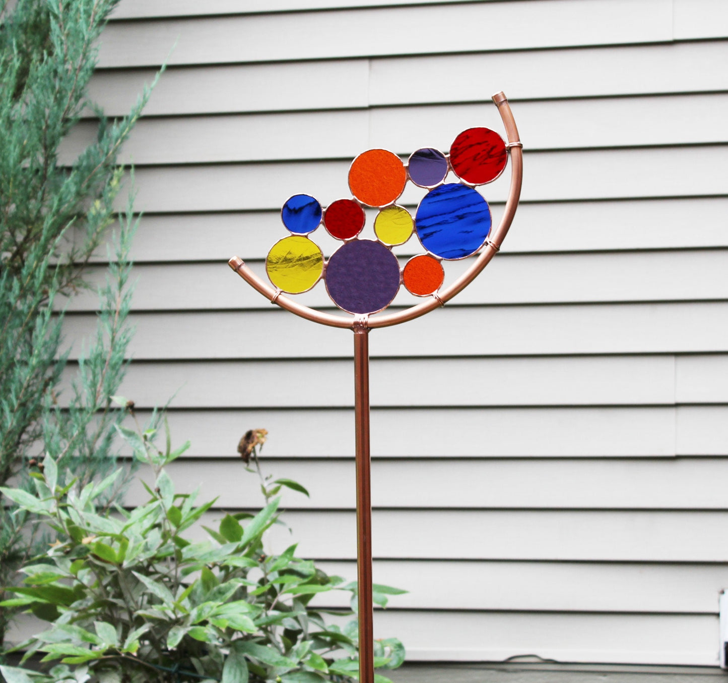 Circle Crescent glass garden art stake. Copper frame. Primary colors.
