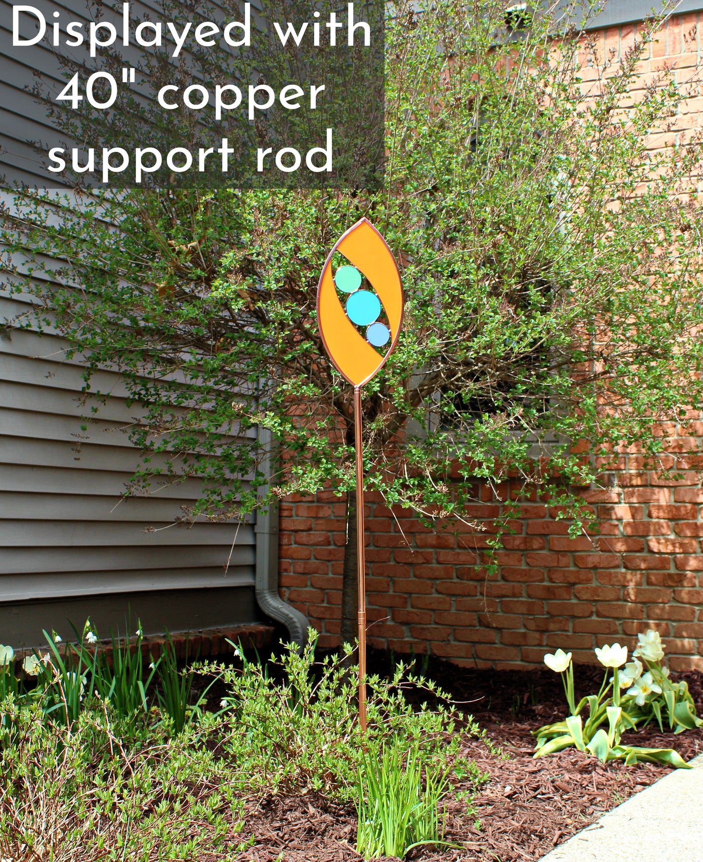 Ellipse shaped glass garden art stake. Persimmon. Copper framed. Opaque glass.