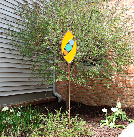 Ellipse shaped glass garden art stake. Marigold. Copper framed. Opaque glass.