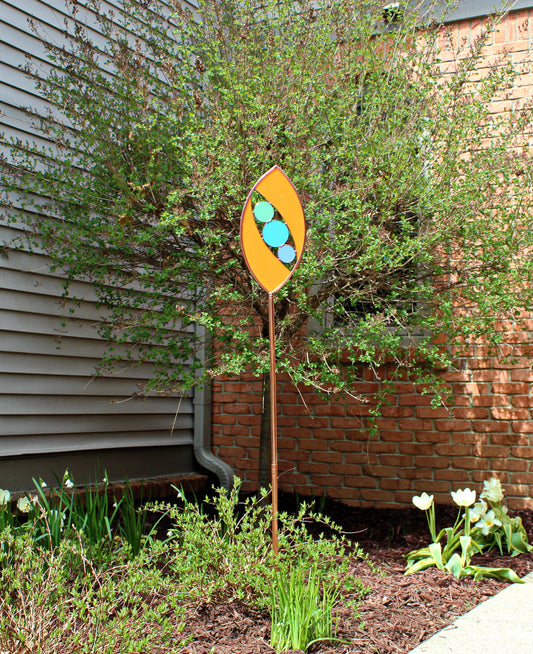 Ellipse shaped glass garden art stake. Persimmon. Copper framed. Opaque glass.