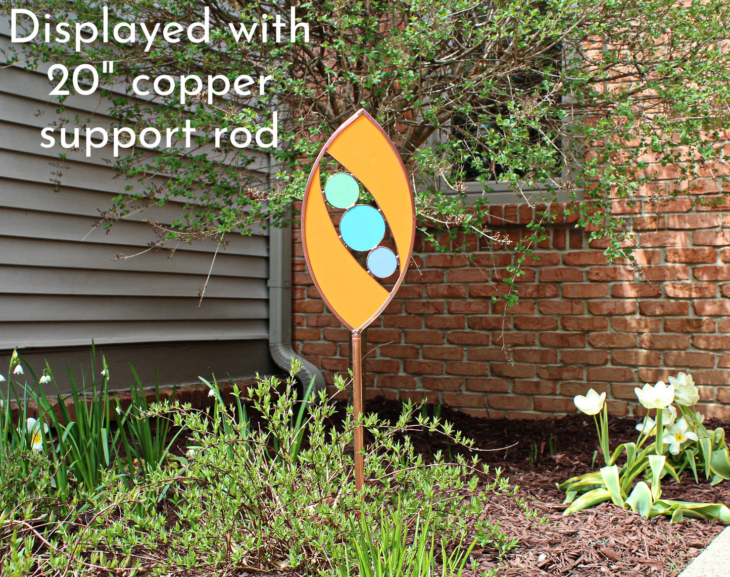 Ellipse shaped glass garden art stake. Persimmon. Copper framed. Opaque glass.