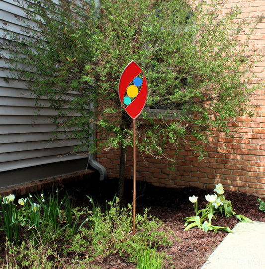 Ellipse shaped glass garden art stake. Red. Copper framed. Opaque glass.