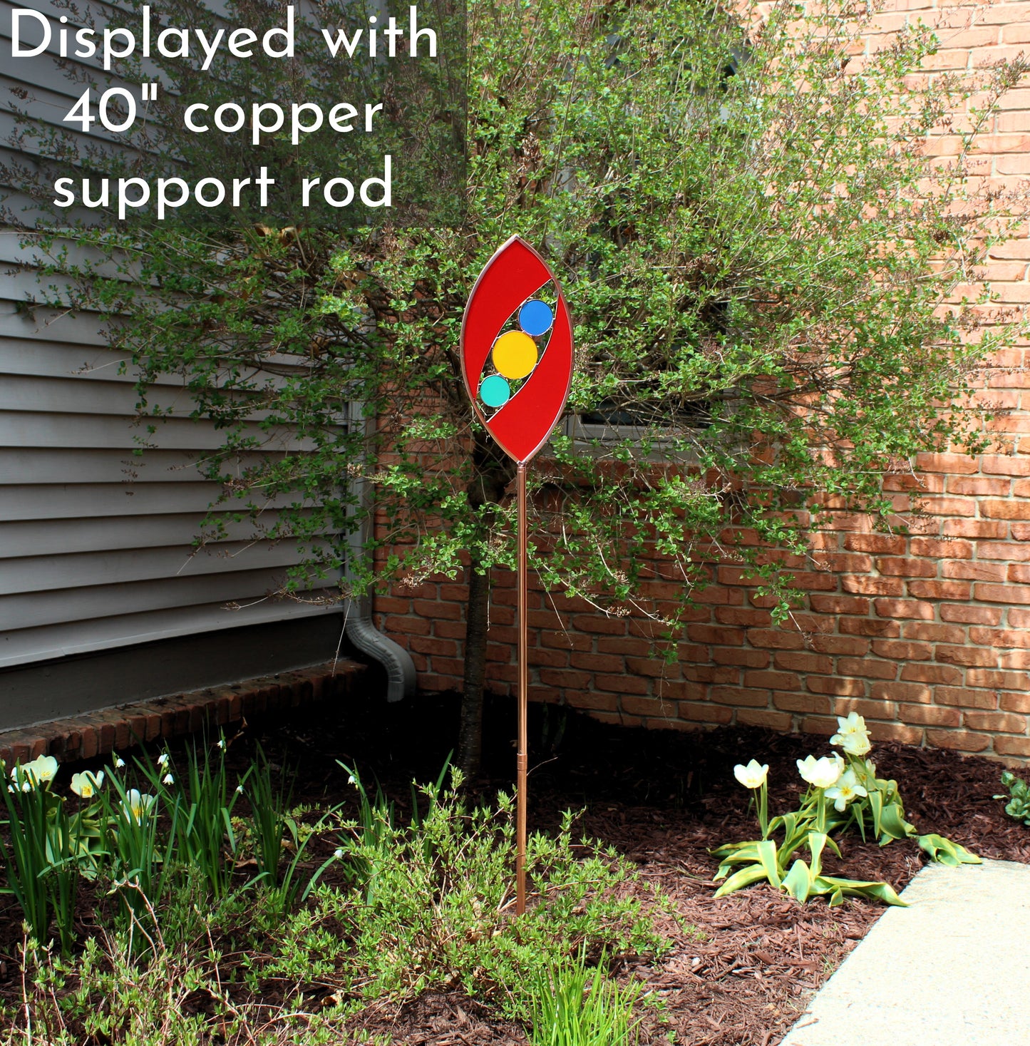 Ellipse shaped glass garden art stake. Red. Copper framed. Opaque glass.