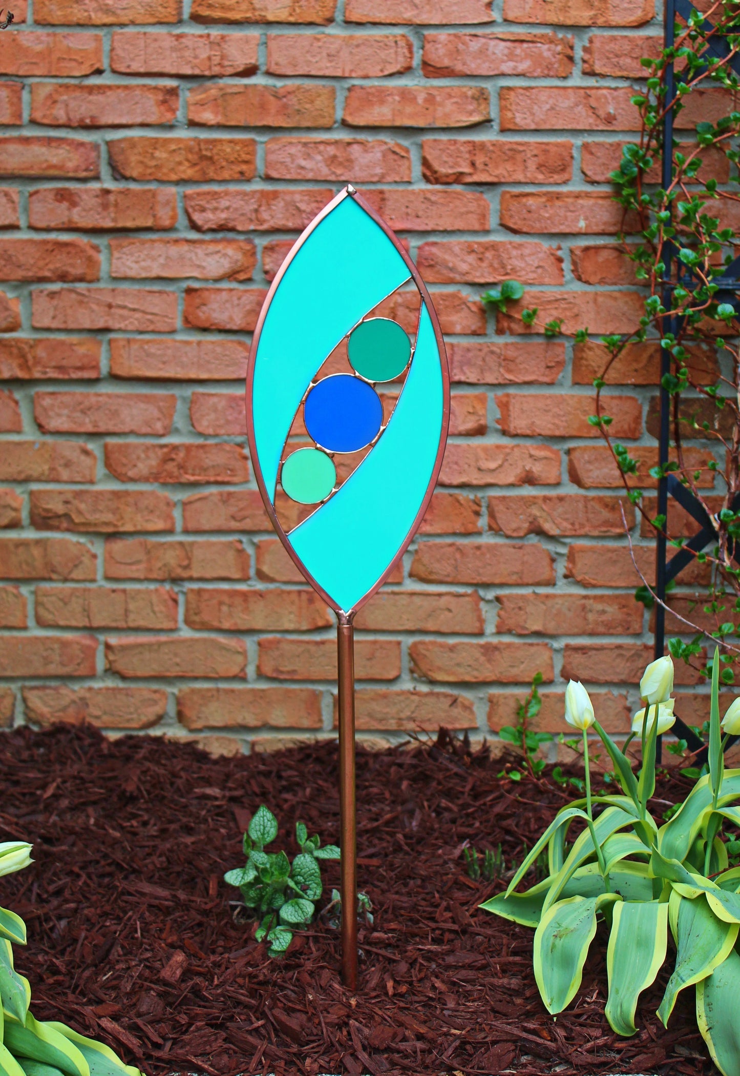 Ellipse shaped glass garden art stake. Turquoise Green. Copper framed. Opaque glass.